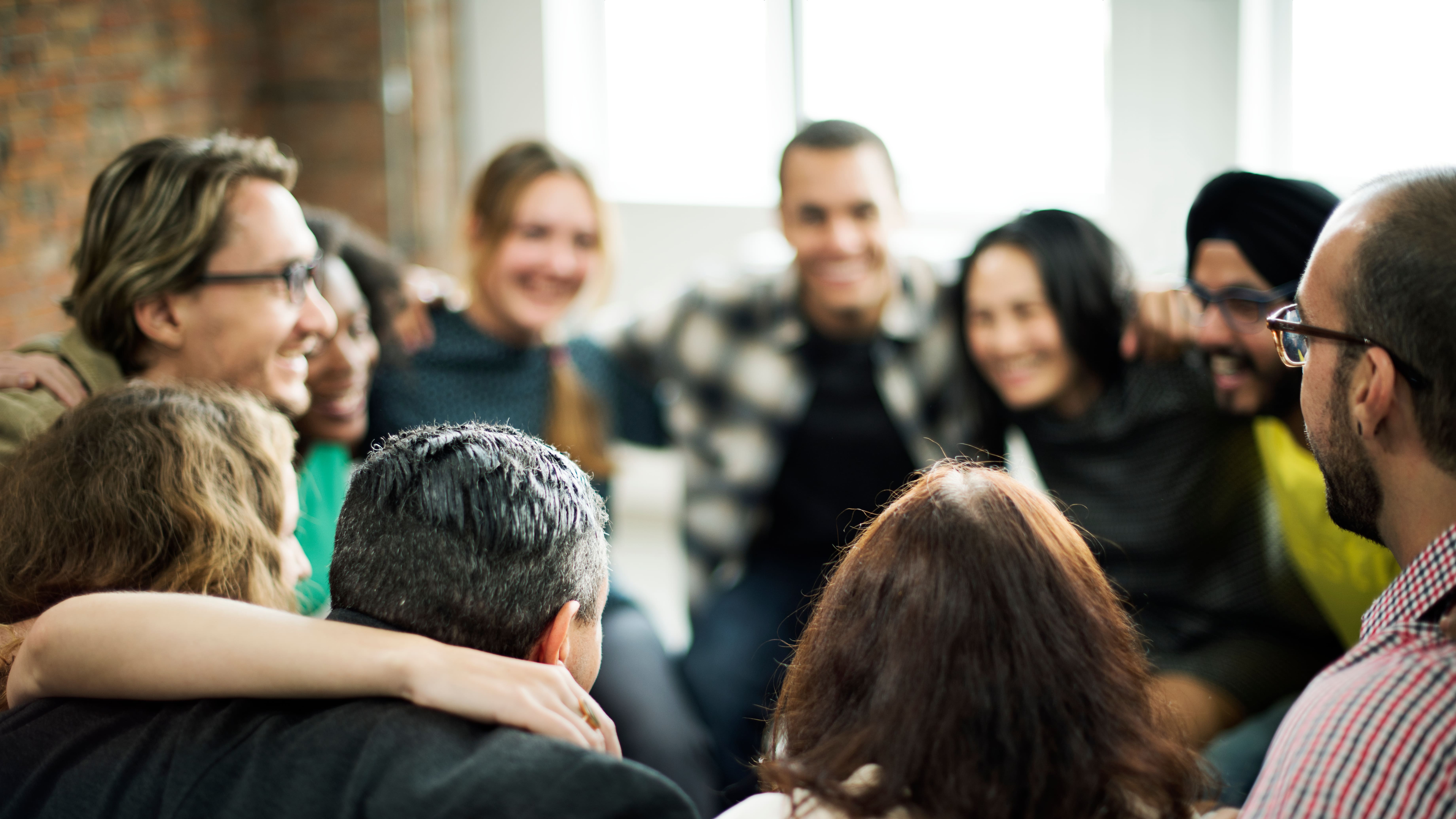 A team gathers with arms around each other